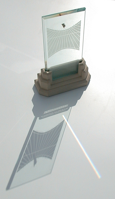 Spectra sundial with its shadow and rainbow prism beam